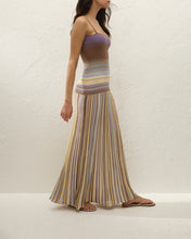 Woman wearing a striped dress with a plain background