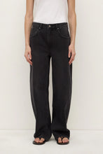 Person wearing black jeans and a white shirt on a white background