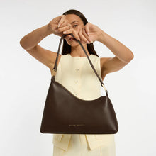 Woman holding a brown leather bag