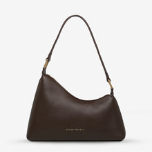 A brown leather bag on a white background