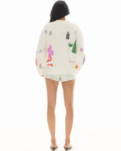 Person wearing a white sweatshirt with colorful graphics on a white background