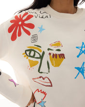 White shirt with colorful abstract designs and 'Viva la Vida!' text.